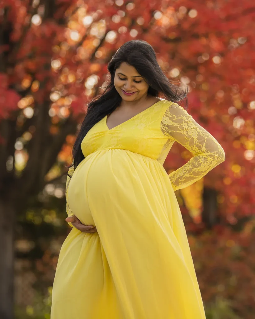 pregnant woman holding her belly while looking down