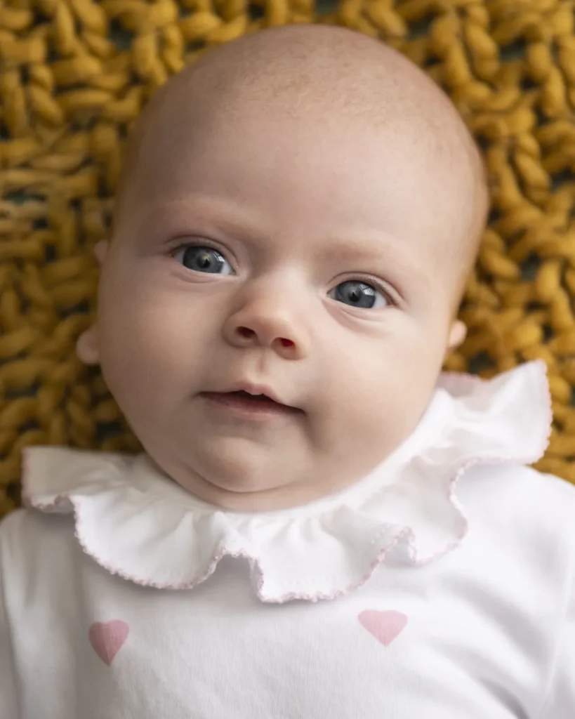 portrait of a newborn baby girl looking at the camera