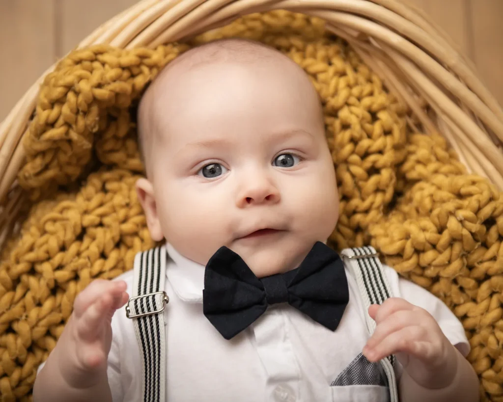 Portrait of a newborn looking at the camera laying on a basket